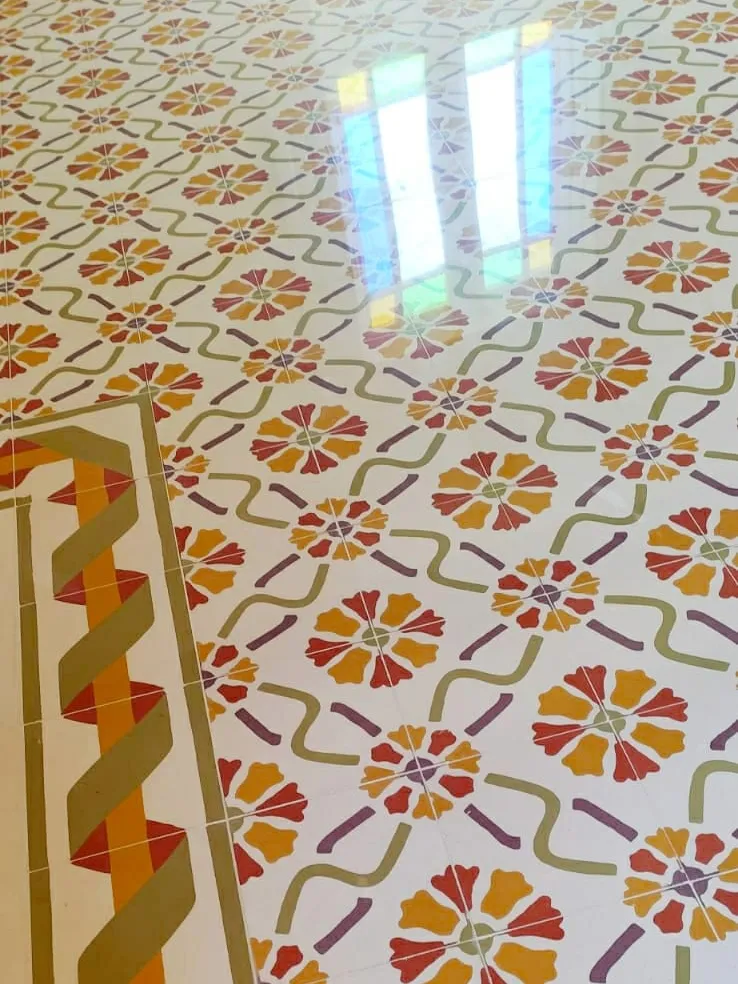 Colourful floral cement tiles edged with a green border