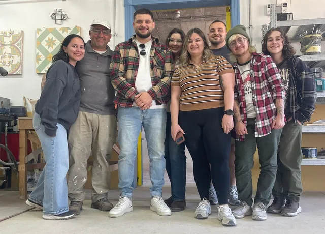 A group gathered in the workshop at the end of a session